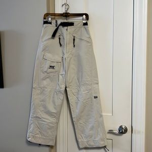 Helly Hansen beige belted snowboard pants with brown trim, 3 front pockets.